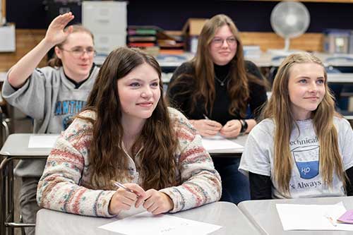 students in a class, student raising hand