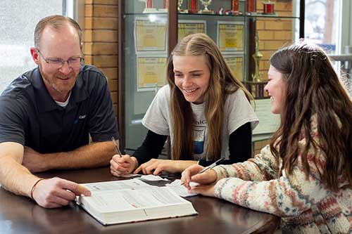 teacher with students at desk